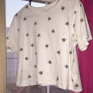 A shirt that has bees on it.